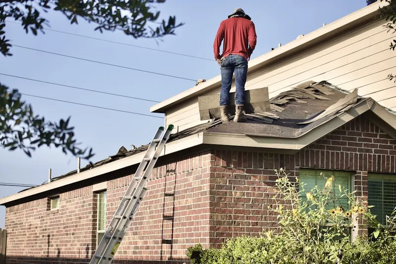Professional roofer working on a residential roof in Saint Andrews Square